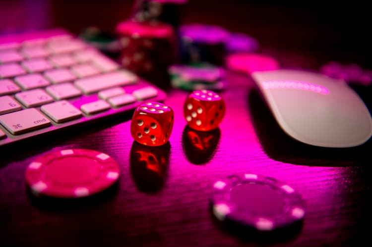dice and poker chips next to keyboard and mouse